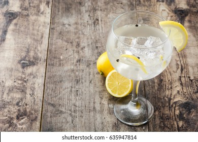 Glass Of Gin Tonic With Lemon On Wooden Background
