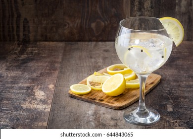 Glass Of Gin Tonic With Lemon On Wooden Background
