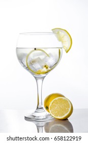 Glass of gin tonic with lemon on white background - Shutterstock ID 658122919