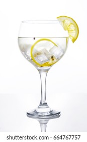 Glass of gin tonic with lemon on white background - Shutterstock ID 664767757