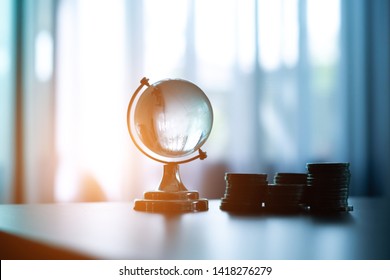 Glass globe and coin on the table in Business finance concept