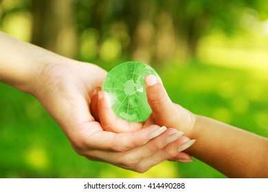 Glass globe in hand - Shutterstock ID 414490288