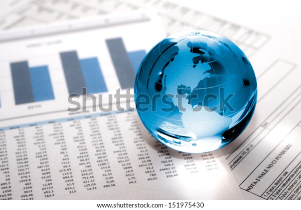 Glass globe\
with North America and business\
papers