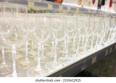 Glass Goblets On The Shelf In The Store. Rows Of Empty Wine Glasses Close Up