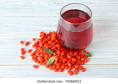 Glass With Goji Juice On Wooden Table