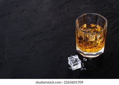 Glass of golden whiskey with ice. Strong alcoholic drink background. - Shutterstock ID 2265601709