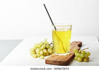 Glass Of Grape Juice And A Bunch Of White Grapes.