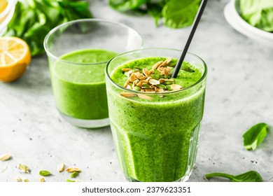 a glass of green healthy detox diet Anti-Inflammatory Breakfast smoothie kiwi cucumber parsley Pineapple Spinach Peanut Butter Banana avocado green tea juice - Powered by Shutterstock