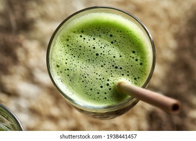 A Glass Of Green Juice With A Bamboo Straw, Top View
