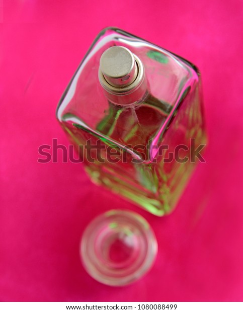 pink and green perfume bottle