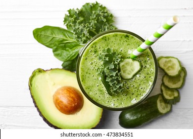 Glass of green vegetable smoothie on white wooden background from top view - Powered by Shutterstock