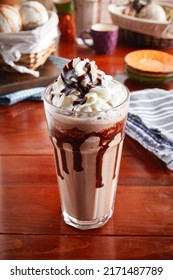 A Glass Of Healthy Fresh Mocha Frappe Isolated On Wooden Background Side View
