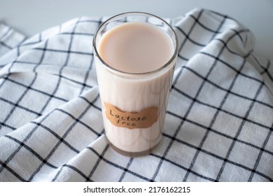 A Glass Of Herbal Milk On A Napkin With A Lactose Free Sign On It