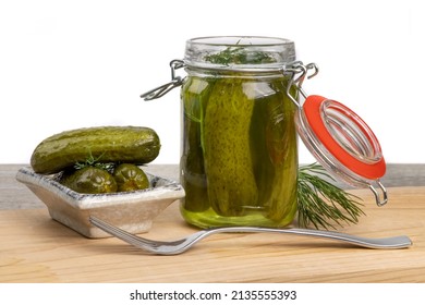 A Glass Home Canning Jar Of Baby Dill Pickles With The Lid Open And Pickles On A Small Plate Showing The Dill Herb