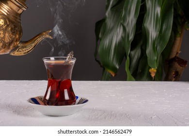 a glass of hot turkish tea on the table