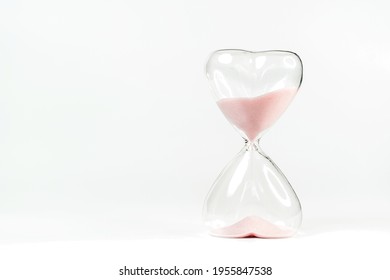 Glass hourglass in the form of hearts with pink sand - Powered by Shutterstock