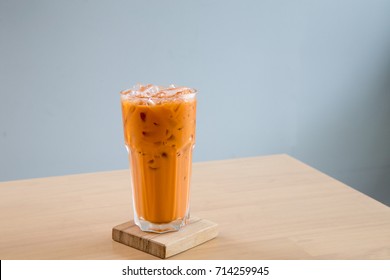 A Glass Of Ice Milk Tea, Fresh And Sweet Dessert On A Wooden Saucer 