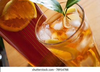 Glass Of Ice Tea With Lemon And Pitcher On A Background