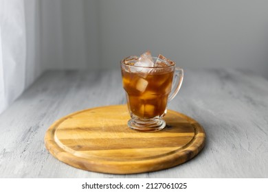 Glass Of A Iced Coffee With Cream Milk On A Wood Desk. Cold Brew Coffee Drink With Ice. Copy Space.