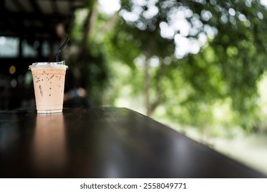 A glass of iced latte coffee on wood table outdoor cafe with bokeh - Powered by Shutterstock