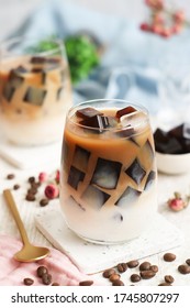 A glass of iced milk latte with fresh homemade Japanese coffee jelly with its bean in background. It's a dessert flavored with coffee, gelatin and sugar. - Shutterstock ID 1745807297