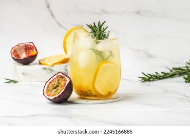 glass of Iced passion fruit soda with lemon and passion fruit half slice on a light background, refreshing drink or beverage with ice, place for text, - Shutterstock ID 2245166885