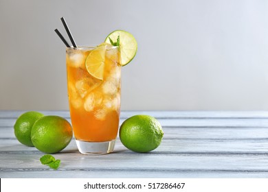 Glass Of Iced Tea With Lime Slices And Mint On Table