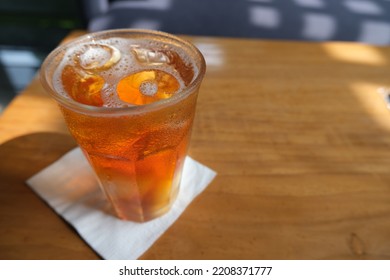 A Glass Of Iced Tea On The Table With Tissue Under It