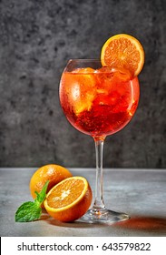 Glass Of Italian Aperol Spritz Cocktail On Dark Table