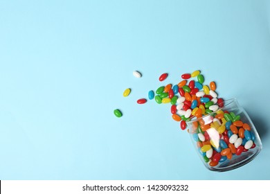 Glass jar with bright jelly candies on color background, flat lay. Space for text - Powered by Shutterstock