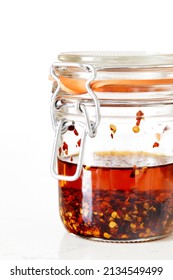 Glass Jar Of Chili Oil On White Surface And Background