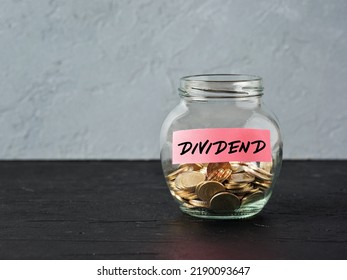 Glass Jar With Coins And The Word Dividend On A Label. Business Finance Investment, Distribution Of Profits Or Dividend Tax