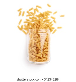 Glass Jar Filled With Dry Rotini Yellow Pasta Over Isolated White Background