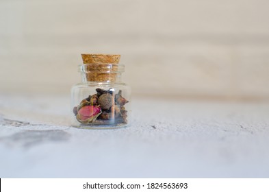 Glass jar filled with scented seasoning, cloves and anise