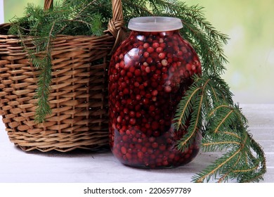 glass jar with fresh cranberries, keep the berries for the winter - Shutterstock ID 2206597789