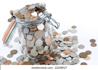 A glass jar full of British coins.