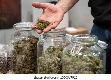 Glass Jar Full Of Cannabis Sativa For Sale At A Market Stall.
