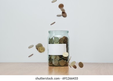 Glass Jar Full Of Falling Coins, Blank Sticker, Money Box. Cash Or Penny Saving.