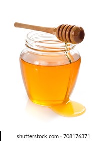 glass jar full of honey and dipper isolated on white background - Shutterstock ID 708176371