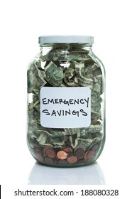 Glass Jar Full Of Money With A White Emergency Savings Label