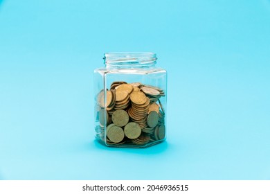 Glass Jar Half Full With Coins.