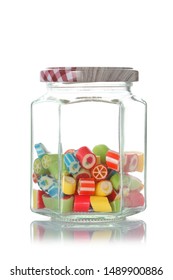 A Glass Jar Half  Full Of Colored Candies With Isolated On White Background With Clipping Path And Copy Space For Your Text