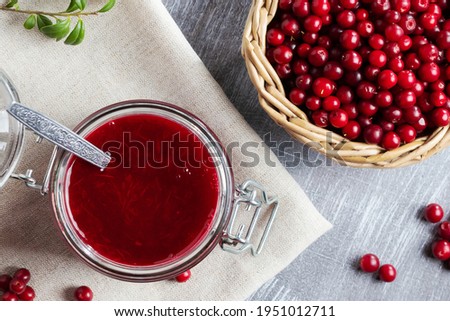Glass jar with homemade lingonberry sauce. Canning lingonberry sauce, top view, flat lay