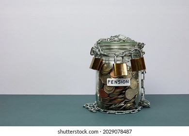 A Glass Jar Labelled Pension Full Of Money Secured With Three Padlocks.Triple Lock Pension Scheme Concept.