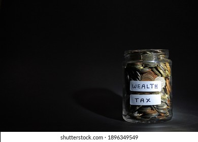 A Glass Jar Labelled Wealth Tax. Financial Taxes Concept.
