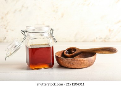 Glass Jar Of Maple Syrup, Bowl And Spoon On Light Wooden Table