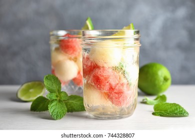 Glass Jar With Melon Ball Drink On Table