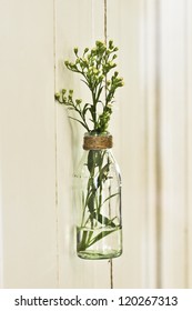a glass jar is refashioned into a vase for fresh flowers