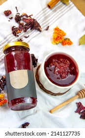 Glass Jar And Small Serving Dish With Dried Rose Petal Jam On Light Textured Cloth Background. Homemade Rose Petal Jam