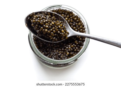 Glass jar and a spoon of black caviar isolated over white. Natural sturgeon luxury delicacy closeup. Seafood delicatessen appetizer. - Shutterstock ID 2275553675